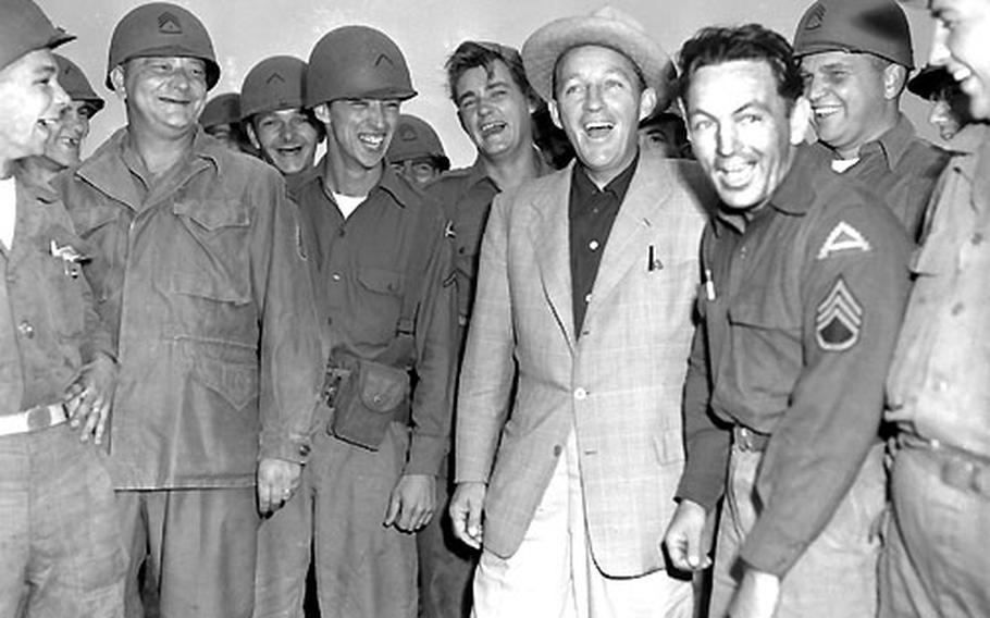 Bing Crosby poses with members of the 7th Army Flight Det.