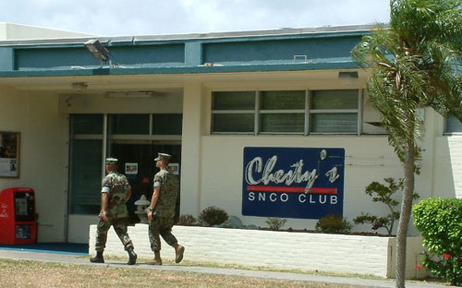 Two Marines enter Chesty&#39;s Senior Non-Commissioned Officer&#39;s club on Tuesday, July 22 at Camp Foster. The club won an award for best large SNCO club in the Marine Corps.