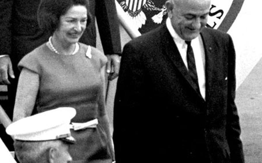 President and Mrs. Lyndon Johnson step down from Air Force One at the Manila airport in October, 1966.