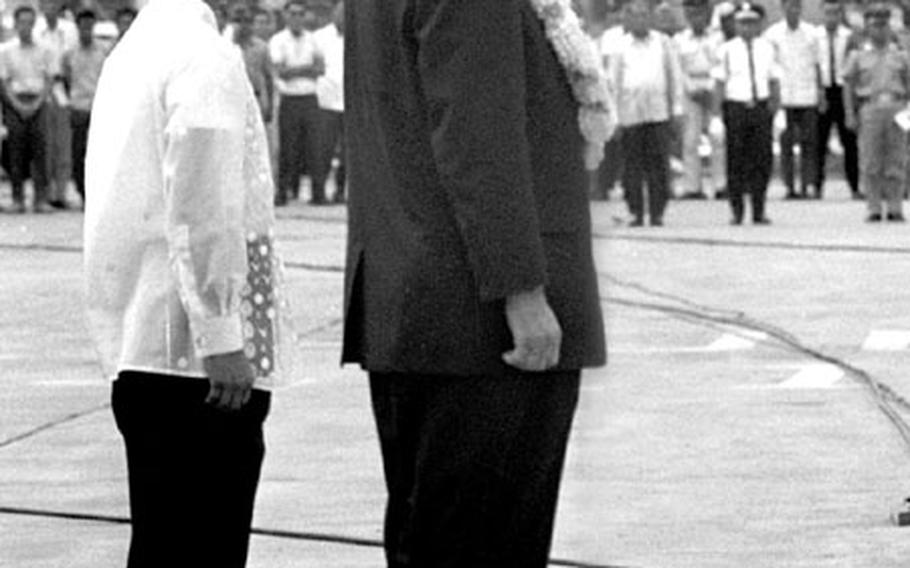 Presidents Johnson and Marcos, during ceremonies at the Manila airport.