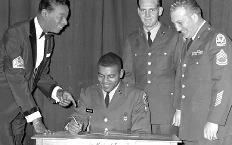 Nat King Cole, left, poses with Army recruiters prior to a show in Seoul in March, 1963. From left to right with Cole are Sp4 Ernest Williams of HQ Det., Korean Mlitary Advisory Group; Sp4 Granette Wade, Signal Station, HQ Det., KMAG; and SFC James Coleman, HQ Det., KMAG, the reenlistment NCO.