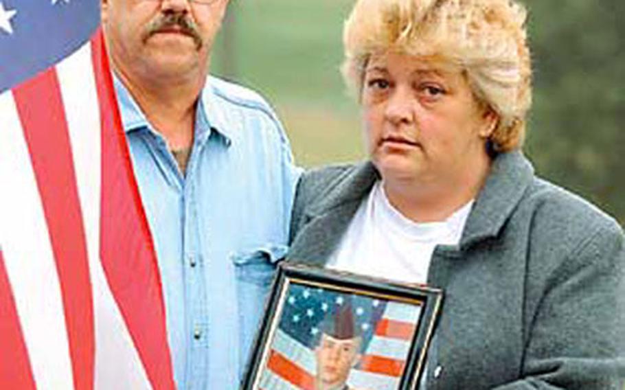 Guy and Mary Hayslett hold a photo of their son, Sgt. Timothy Hayslett, who was killed Saturday in Iraq. A funeral was held Monday in Pennsylvania for Hayslett, who was a member of Headquarters and Headquarters Company, 1st Battalion, 37th Armored Regiment, 1st Brigade of the 1st Armored Division.