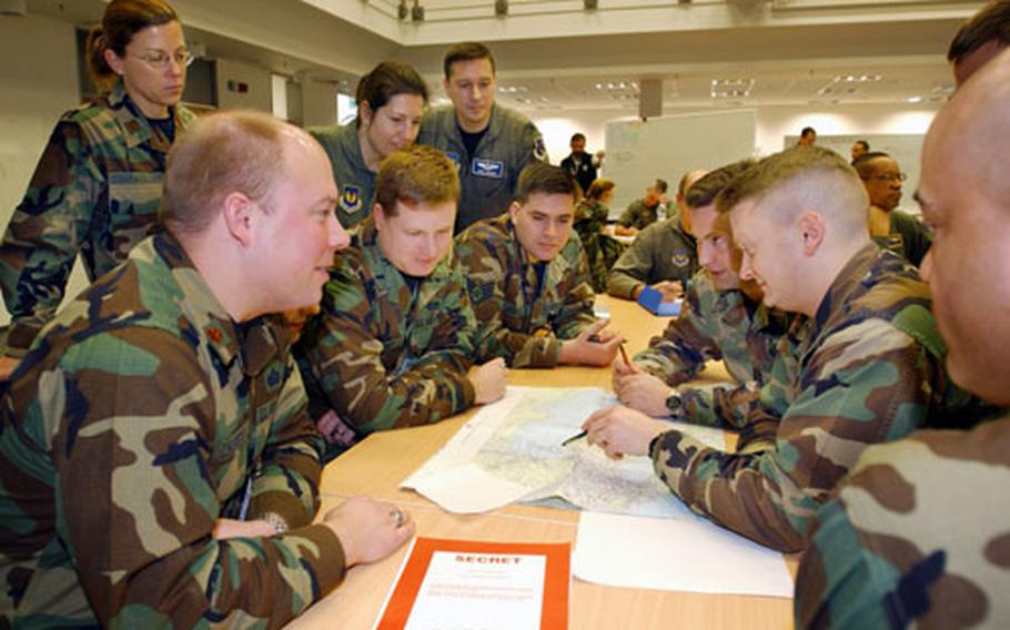 U.S. airmen plan for combat air operations Wednesday during the first phase of Austere Challenge 2004. The three-phase exercise is designed to certify U.S. Air Forces in Europe&#39;s ability to perform its mission as a warfighting headquarters.