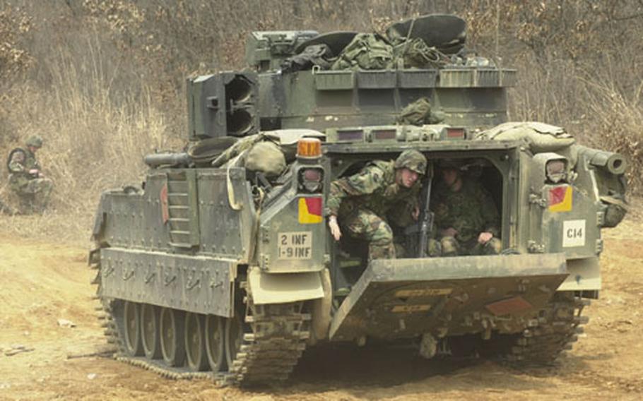 Members of the 1st Battalion, 9th Infantry Regiment based at Camp Hovey, South Korea, practice for gunnery training at Rodriguez Range last week. The dismounts, soldiers in the back of the Bradley fighting vehicle, are about to “take” a bunker.