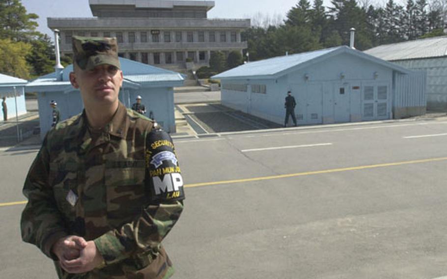 Spc. Craig Lau, a tour guide, stands near conference row in the Joint Security Area Wednesday at Panmunjom during a media tour. The North Korean border runs through the middle of the buildings. Later this year, U.S. troops will no longer patrol inside the Demilitarized Zone, as the mission will be turned over to South Korean Army soldiers. A handful of U.S. soldiers will remain with the Joint Security Battalion, which will still be led by a U.S. Army officer.