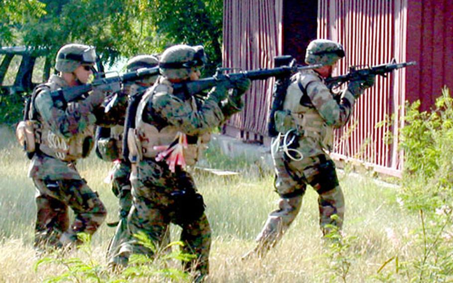 The 13-man assault team of 7th Platoon, 2nd FAST Company approach the first of two targets during a training raid.