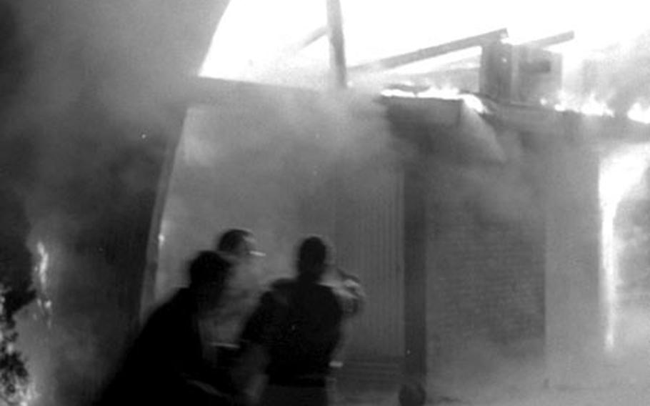 Firefighters try to control the blaze at Yongsan's main post chapel.