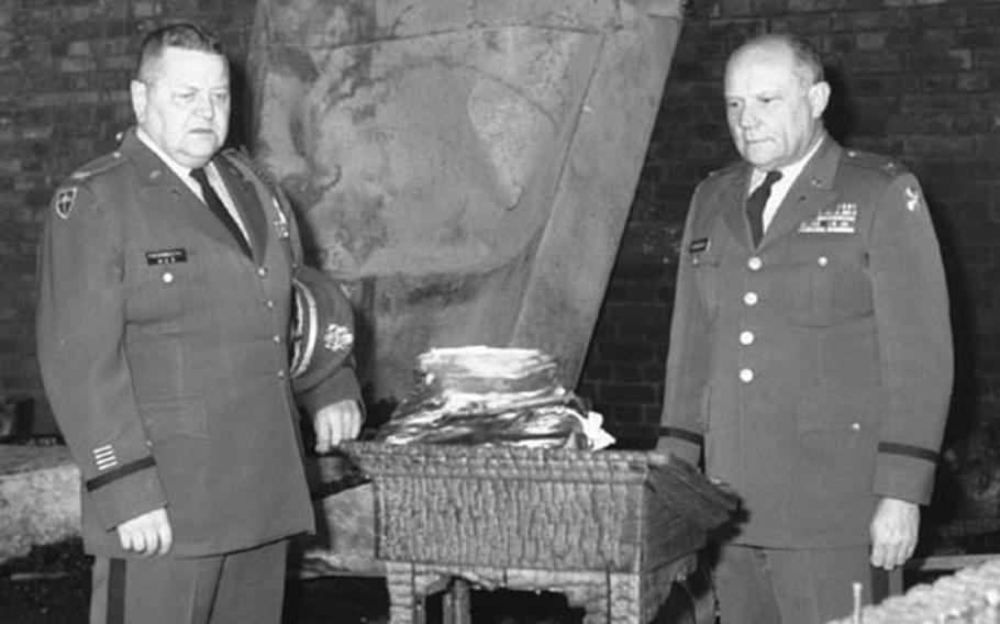 Deputy 8th Army Chaplain Col. Alphonse Fiedorczyk, left, and 8th Army Chaplain Col. David Reardon examine the charred remnants of the main post chapel's pulpit.