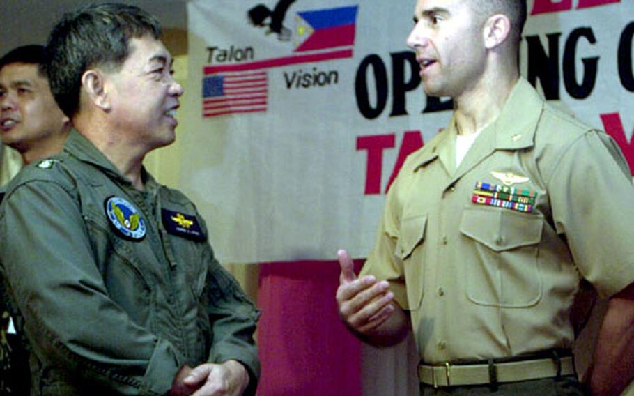 The co-Directors of Exercise Talon Vision 05, Philippine Air Force Col. Andres Largo, left, and U.S. Marine Maj. Peter Calogero, talk after the opening ceremony for the bilateral training.