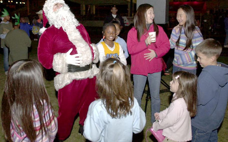 Santa Claus demonstrates a hearty “Ho, ho, ho” to the children.