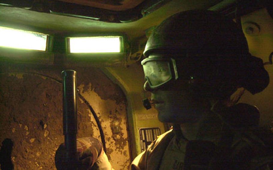 Staff Sgt. Joshua Garrett of the Black Sheep gets ready to dismount from a Bradley Fighting Vehicle and conduct a patrol in the Taji countryside.