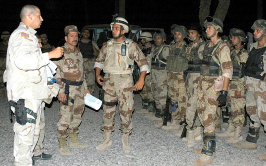 Lt. Aaron Lefton, 29, of Manhattan, gives instructions to Iraqi soldiers before leaving Camp Justice.