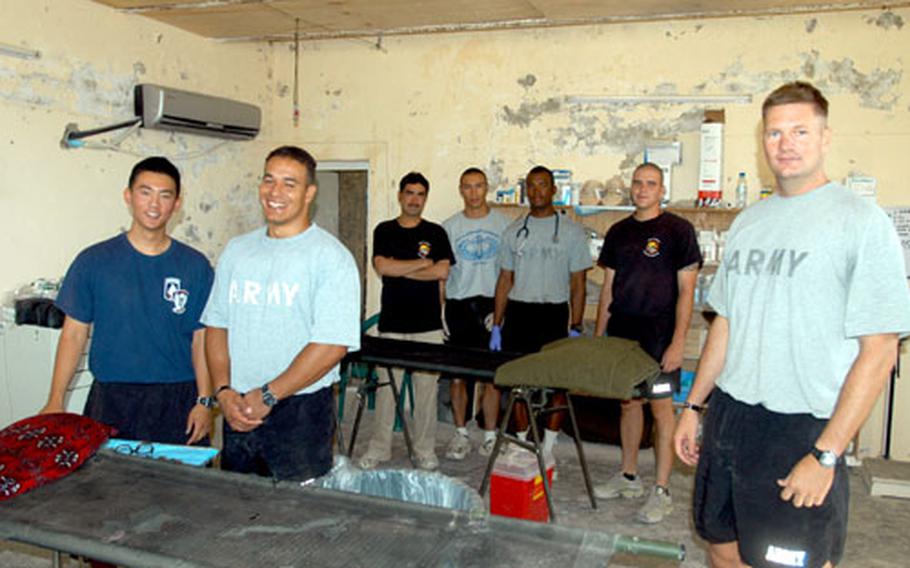 Forward Operating Base Sweeney’s medical team takes a break for a photo after sick call Sunday morning in the base aid station. They are, from left, Spc. Jeeun Park, Sgt. Gary Santiago, interpreter Hikmat Ullah, Cpl. Aaron Medina, Sgt. Samuel Fitz, Sgt. Scott Dinse and Staff Sgt. Jonathan Neal. Dinse is the only soldier who isn’t a medic; he runs the camp dining facility but is cross-training to become a medic.