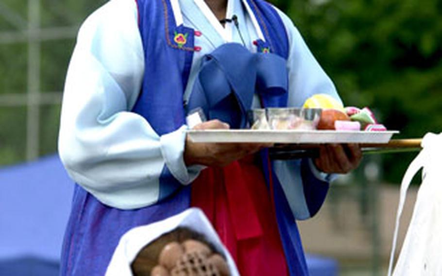 A performer conducts the “daedong gut,” or shaman’s exorcism, during the Hannam Village Community Festival.