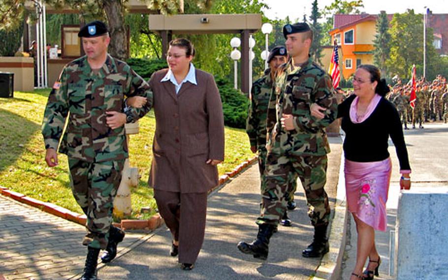 Army Lt. Col. Gerald O’Connor, left, escorts Maria Wayman and Capt. Alexander Bullock escorts Maria Nieves to the dedication ceremony for the Nieves Webb Consolidated Dining Facility Sept. 9 on Warner Barracks. Wayman is the mother and Nieves is the sister of Spc. Isaac Nieves.