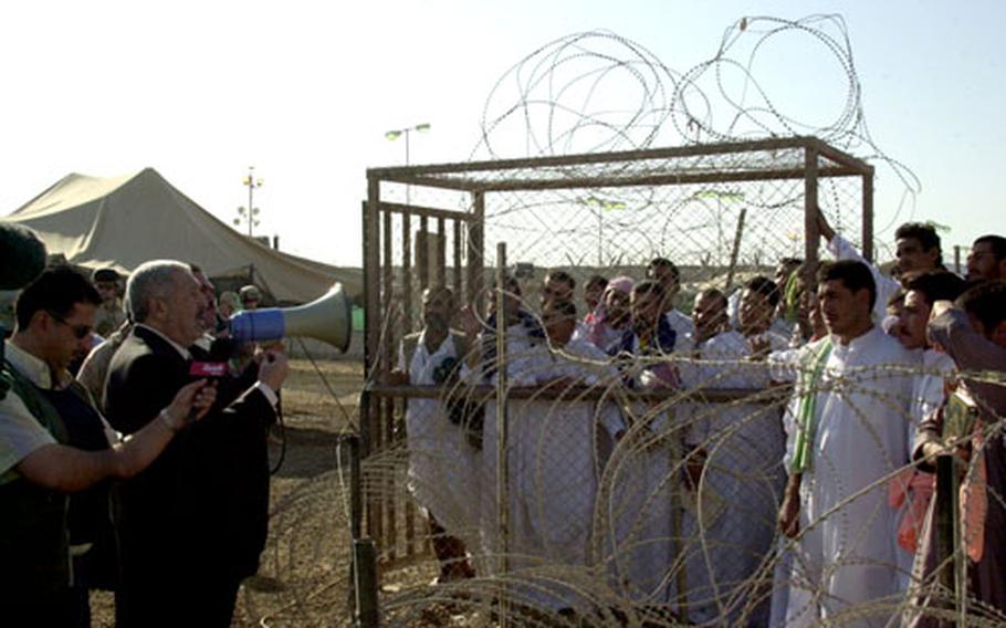 Iraqi Deputy Prime Minister Abed Motlaq Al-Jabouri urges 320 prisoners about to be released from Abu Ghraib prison Saturday to participate in the Oct. 15 constitutional referendum.