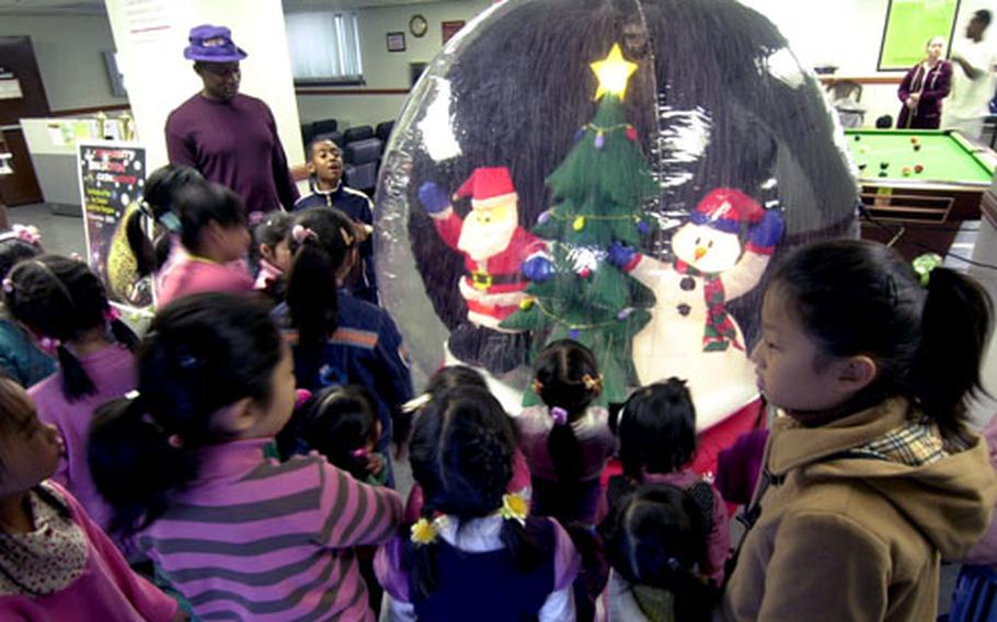 A group of girls from the the Sun Duk Orphanage check out the holiday decorations during a holiday visit at Yongsan Garrison, South Korea, on Friday.