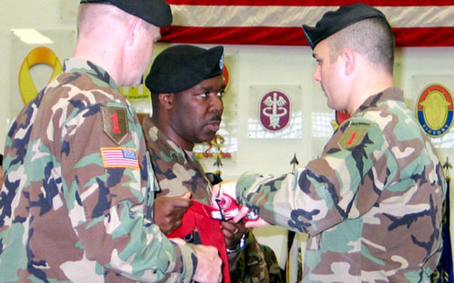 Lt. Col. Gerald O&#39;Connor, 82nd Engineer Battalion commander, left, Sgt. 1st Class Reginald Clayton, middle, and Capt. Xander Bullock case the colors of the battalion&#39;s Company A.