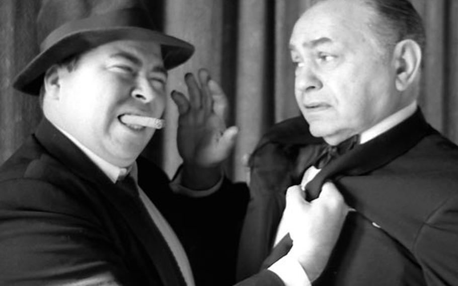 Movie tough guy Edward G. Robinson pretends to cower at the rough treatment being meted out by Stars and Stripes' legendary columnist, Al Ricketts.