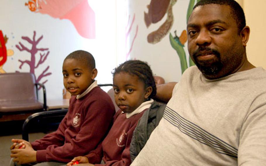 Retired airman Greg Coulson and his children, Danniel, 6, and Ethan, 9, wait for an appointment at the Lakenheath pediatrics clinic. The pediatrics ward is scheduled to move into a new space in the main building as part of upcoming refurbishments.