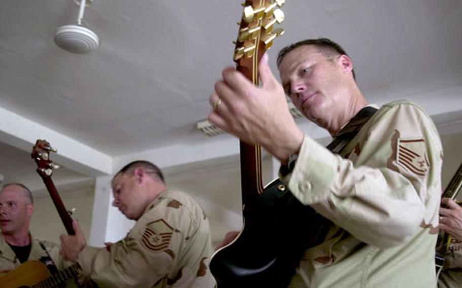 Members of Wild Blue Country, a part of the Air Force Academy Band, play at an orphanage Thursday in Djibouti.