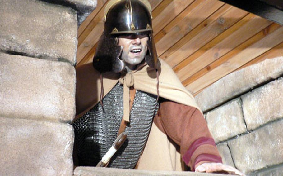 A lifelike mannequin of a Roman guard stands atop a re-created section of Hadrian’s Wall in the Birdoswald Fort exhibition.