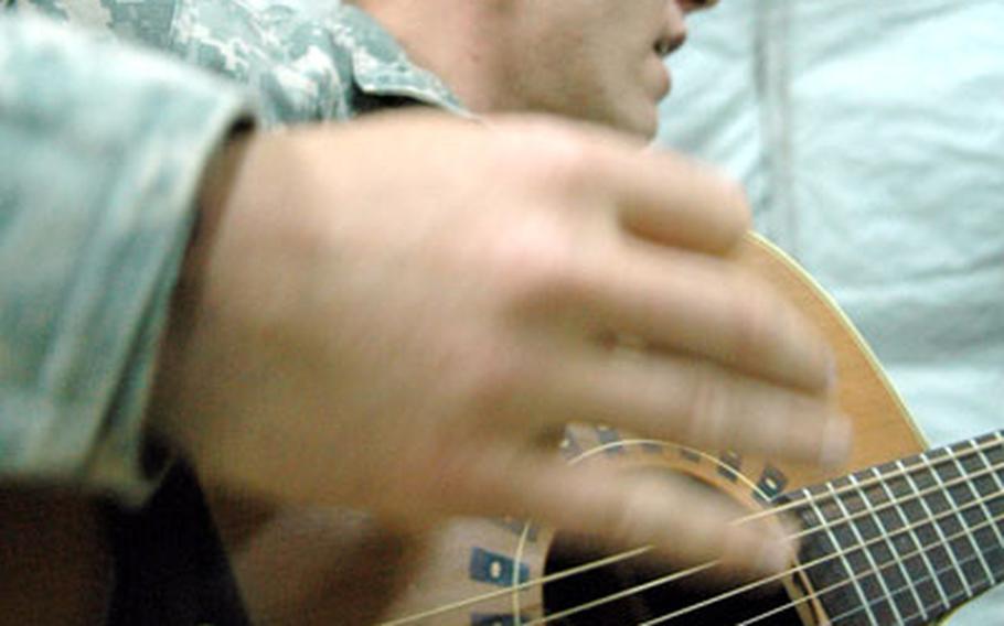 Joshua Revak, singer of “The Bandit Song,” practices his guitar and vocals while he was deployed to Camp Nimur in northwest Iraq earlier in the year. Revak, who has recorded numerous songs about fallen comrades and life in Iraq, said he has lost inspiration to sing and play after the death of his mentor, 1st Sgt. Aaron Jagger.