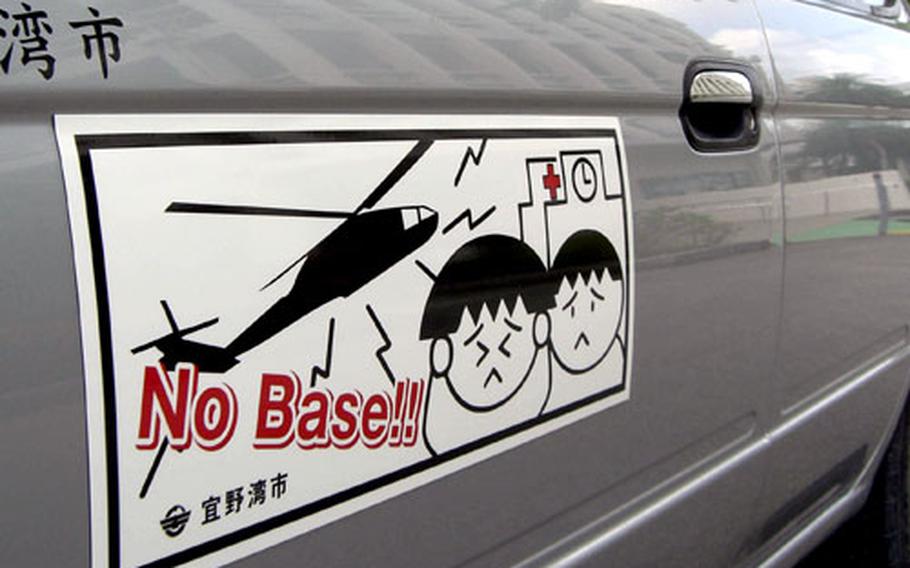 New anti-base bumper stickers and magnetic strip signs are the new additions to all city cars in Ginowan. Mayor Yoichi Iha on Thursday revealed the city’s bumper-sticker campaign urging the immediate closure of MCAS Futenma.