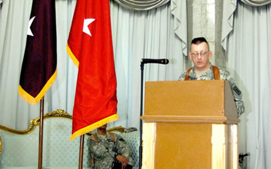 Col. Steven W. Swann, commander of V Corps’ 30th Medical Brigade, makes his farewell remarks during a transfer-of-authority ceremony in the Al Faw Palace ballroom at Camp Victory, Iraq, on Thursday.