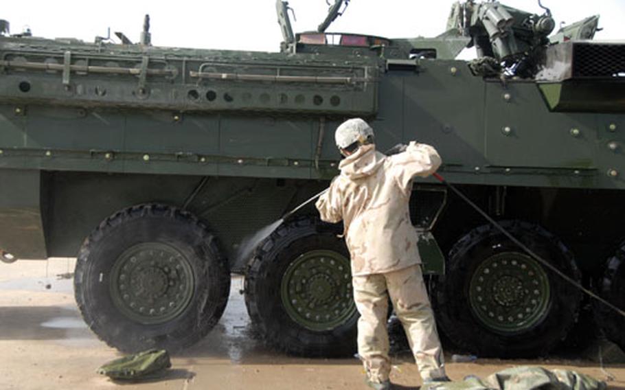 Pvt. Jordan Skinner, 20, of Cinncinati, washes one of 172nd Stryker Brigade’s more than 200 Stryker vehicles Sunday afternoon. After a four-month extension of their Iraq tour in August, the brigade is heading home to Fort Wainwright, Alaska. Skinner and other soldiers are in the middle of a more than weeklong process of cleaning the vehicles before they are shipped back to Alaska.