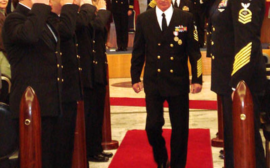 Forziati walks through a formation of "sideboys" Thursday at his retirement ceremony after he had asked Adm. Harry Ulrich, commander of Naval Forces Europe, permission to go ashore one final time.