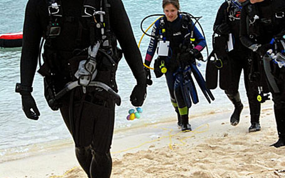 Marine Master Sgt. Mark Kitashima, of Camp Hansen, comes out of the water after collecting eggs during the underwater Easter egg hunt that 18th Services held at Kadena Marina Saturday morning. "I wanted to take my daughter out," he said.