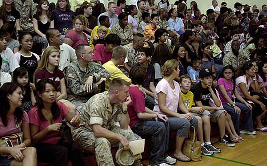 Students, parents and other family members crowd the bleachers at Kubasaki High School&#39;s gym for an orientation Thursday. Department of Defense Dependents Schools-Pacific students head back to school Monday.