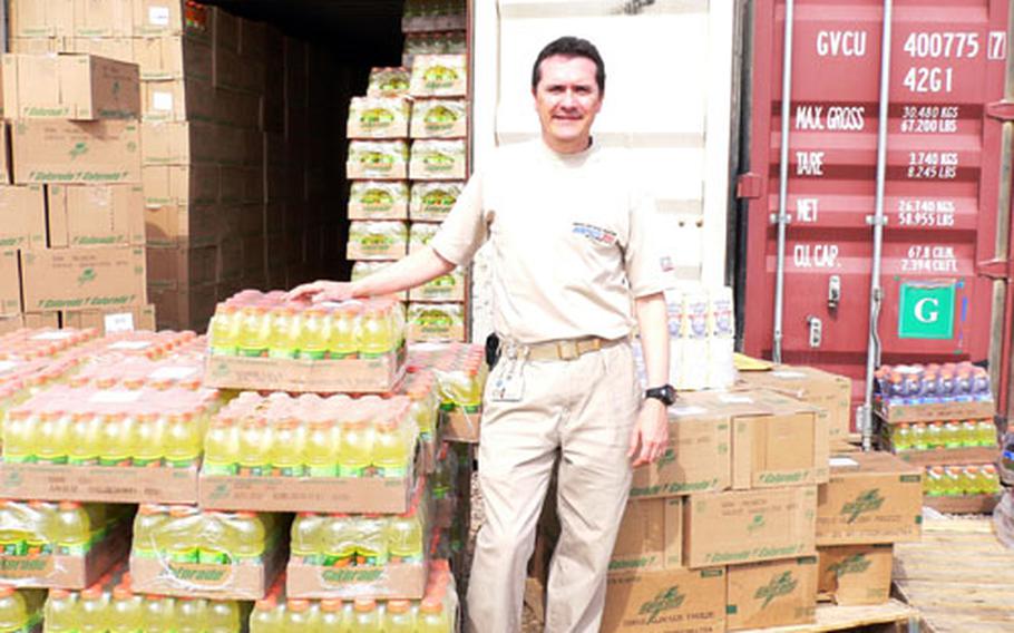 Mark Neely, AAFES main store manager at Yokota Air Base, Japan, stands in the container yard outside of the Balad East PX at Balad Air Base, Iraq, where Neely was deployed from February to August.