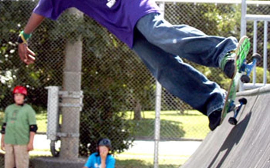 Jamari Wesley, 12, practices his "axle stall" on the half-pipe.