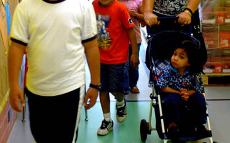 From left: Albert Leuauti, 10, and his family including Aizaiah, 7, and Alrenetta, 5, Matt, Mom Unu and her baby, Toa, 2, check out Netzaberg Elementary School on Thursday.