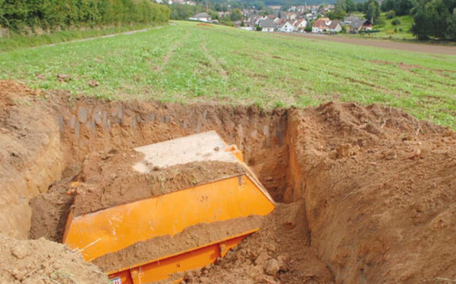 A construction dumpster covers an unexploded World War II bomb on the outskirts of Hochspeyer, Germany. Three bombs from the era have been discovered near the village, and about 500 residents will be evacuated on Monday when an explosives team will defuse the bombs.