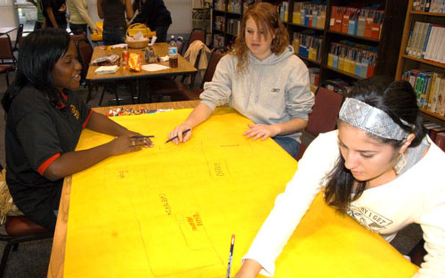 Mentors-in-training, from left, Zaccai Brown, Jordan Wicinske and Clarissa Rendon draw a map of Kadena High School during a November workshop.