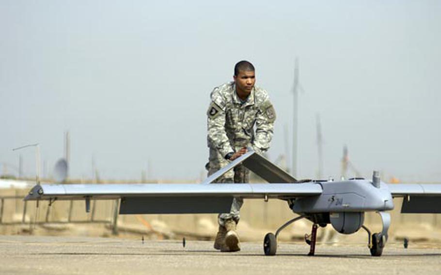 Pvt. Laquay Harvey, an unmanned aerial vehicle crew chief assigned to the 504th Military Intelligence Company, recovers a Shadow 200 UAV at a small runway on Forward Operating Base Kalsu. The 504th, deployed from Grafenwoehr, Germany, can provide the 172nd Infantry Brigade an around- the-clock birds-eye view with the Shadow.