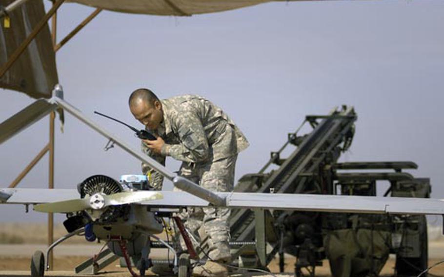 Spc. David Reyes, an unmanned aerial vehicle crew chief assigned to the 504th Military Intelligence Company, conducts a preflight check on a Shadow 200 UAV at Forward Operating Base Kalsu. The 504th, deployed from Grafenwoehr, Germany, can provide the 172nd Infantry Brigade an around-the-clock birds-eye view with the Shadow.