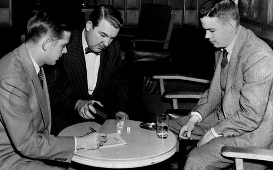 Cartoonist Bill Mauldin, right, joins Cecil Brownlow of International News Service and Earnest Hoberecht of United Press in a "sporting engagement" at the Correspondents Club in Tokyo.