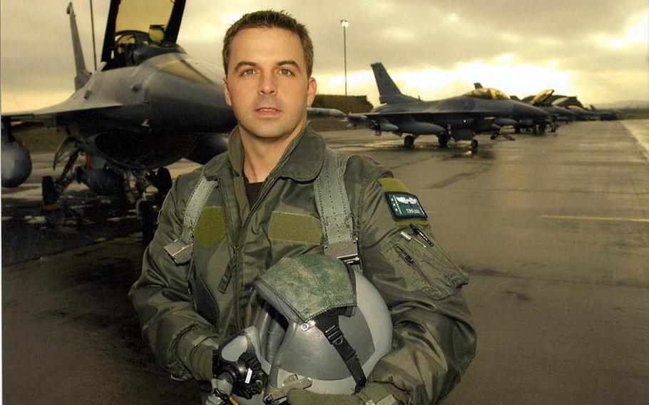 Air Force Maj. Troy Gilbert, an F-16 pilot, poses in front of a line of jets in a photo taken in 2001 or 2002. Gilbert was killed on Nov. 27, 2006, when his F-16 crashed in support of coalition troops under attack north of Baghdad. His body was never recovered. Gilbert's family and friends recently waged a successful grassroots effort to get the Department of Defense to continue looking for the pilot's remains despite the fact that the U.S. has pulled out of Iraq.