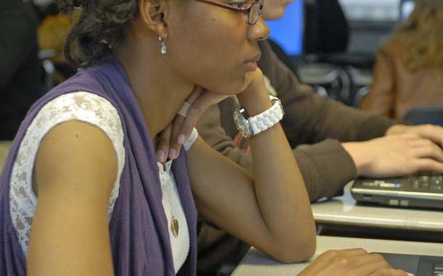 Wiesbaden High School seniors Alexandria Beverly, 18, and Joseph Griffith, 18, use laptops during a sociology class. The computers were issued to them as part of a DODDS pilot program.