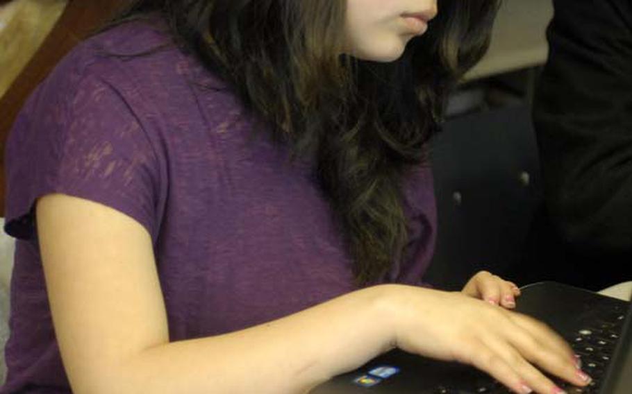 Wiesbaden High School junior Nicole Butron, 17, takes notes with her laptop during a recent class at the school. Wiesbaden students and teachers were recently issued laptops as part of a pilot program.