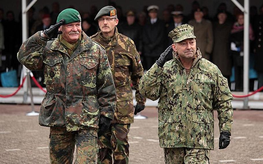 German Gen. Wolf Langheld, left, and U.S. Adm. James G. Stavridis salute while passing a formation of NATO troops during a ceremony in which Langheld handed over command of NATO's Allied Joint Force Command Brunssum.