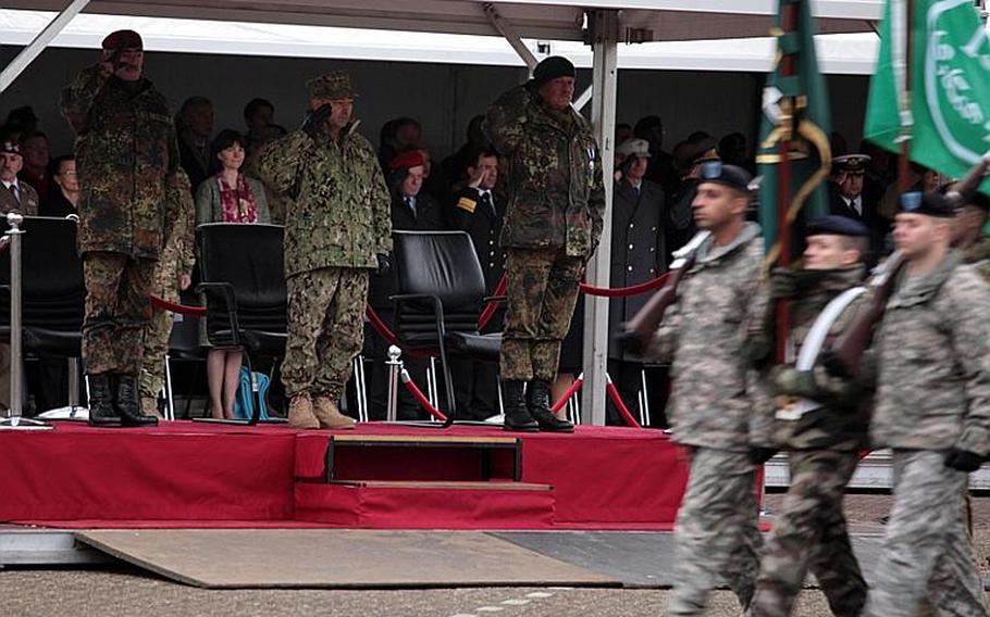 German Gen. Hans-Lothar Domröse, U.S. Admiral James G. Stavridis and German Gen. Wolf Langheld salute as a NATO color guard passes by during a change of command Friday at NATO's Allied Joint Forces Command Brunssum.