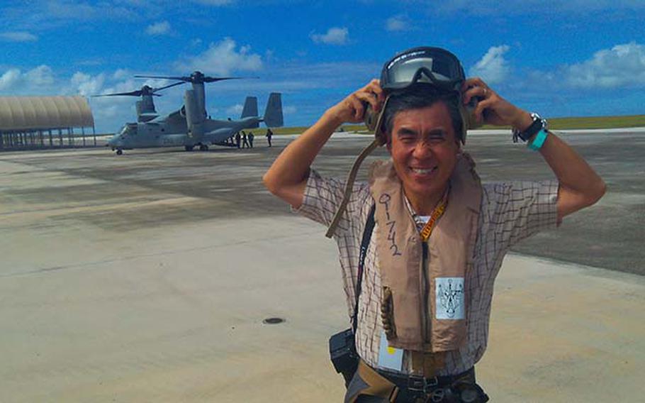 Toshio Matsumura, Japan's Deputy Consul General on Guam, takes off his helmet after riding in the MV-22 Osprey Thursday, Dec. 13, 2012, at Andersen Air Force Base. Matsumura was among a group of dignitaries, politicians and reporters invited by the Marines for a familiarization flight on the helicopter-airplane hybrid while it's participating in exercise Forager Fury on Guam and Tinian.