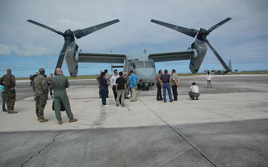 Civilian passengers check out the MV-22 Osprey Thursday, Dec. 13, 2012 at Andersen Air Force Base before taking a flight. Three Ospreys from 1st Marine Aircraft Wing out of Okinawa, Japan arrived in Guam this week to participate in exercise Forager Fury, the first for the Japan-based aircraft since arriving on Okinawa this fall.