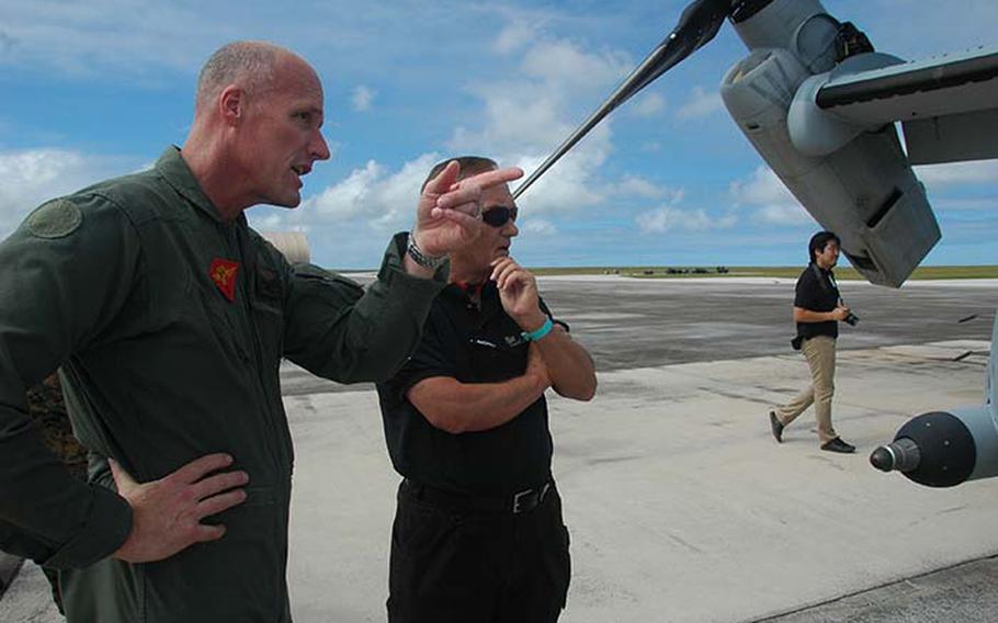 Maj. Gen. Christopher S. Owens, commander of the 1st Marine Aircraft Wing, (left), talks with a civilian about the MV-22 Osprey, the Marines helicopter-airplane hybrid, which has been used since 2006 for missions in Iraq, Afghanistan, Haiti and Libya. Owens told the group the Osprey is revolutionary, both for combat and humanitarian operations.