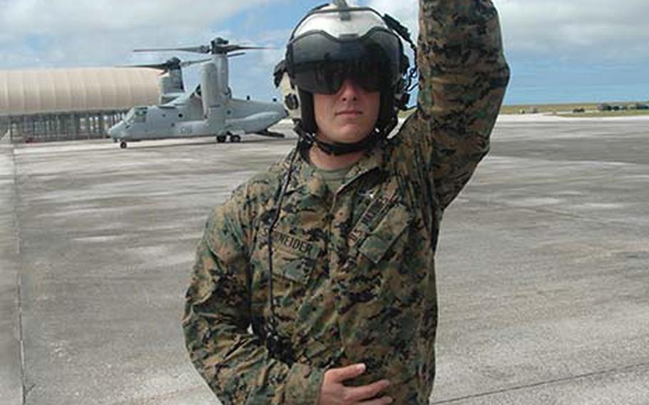 Osprey crew chief Marine Sgt. Jeff Schneider, from the 1st Marine Aircraft Wing out of Okinawa, Japan, directs a group of civilian passengers to the MV-22 Osprey at Andersen Air Force Base, Thursday, Dec. 13, 2012. Three Ospreys from the wing arrived on Guam this week to participate in exercise Forager Fury, the first for the Japan-based aircraft since arriving on Okinawa this fall.